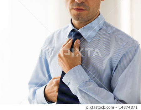 close up of man in shirt adjusting tie on neck close up of man in shirt adjusting tie on neck 14874871