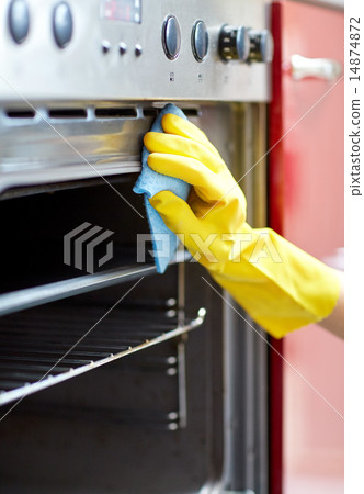 close up of woman cleaning oven at home kitchen close up of woman cleaning oven at home kitchen 14874872