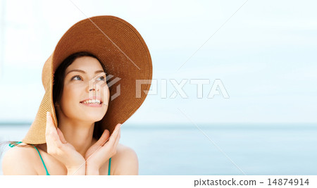 girl in hat standing on the beach girl in hat standing on the beach 14874914