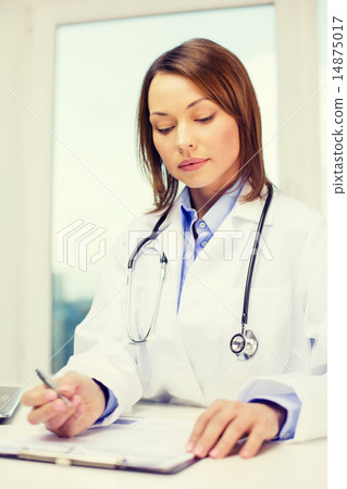 busy doctor with laptop computer and clipboard busy doctor with laptop computer and clipboard 14875017