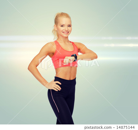 smiling woman with heart rate monitor on hand 14875144