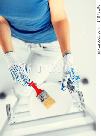 woman with paintbrush and paint pot 14875190