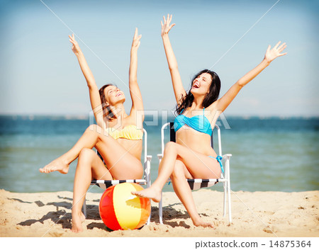 girls sunbathing on the beach chairs girls sunbathing on the beach chairs 14875364