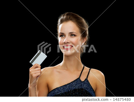 smiling woman in evening dress holding credit card 14875480