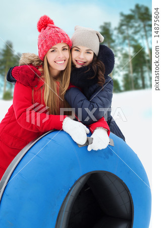 happy girl friends with snow tubes outdoors happy girl friends with snow tubes outdoors 14875604