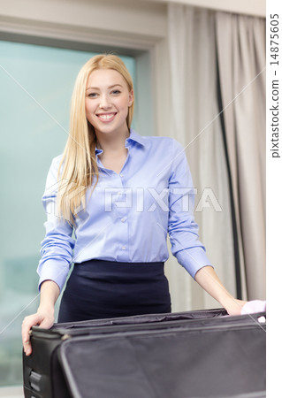businesswoman packing things in suitcase businesswoman packing things in suitcase 14875605