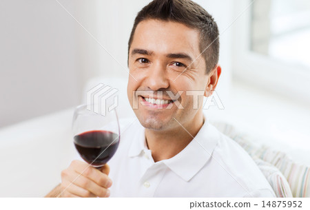 happy man drinking red wine from glass at home happy man drinking red wine from glass at home 14875952
