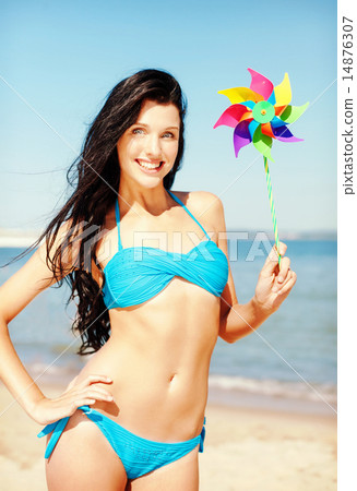 girl with windmill toy on the beach 14876307