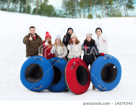 group of smiling friends with snow tubes group of smiling friends with snow tubes 14876543