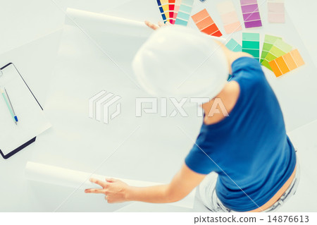 woman with color samples and blueprint 14876613