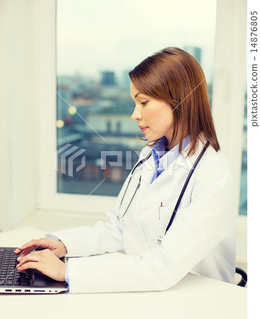 busy doctor with laptop computer busy doctor with laptop computer 14876805