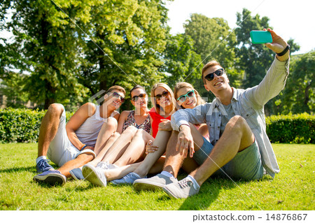smiling friends with smartphone making selfie 14876867