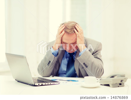 upset older businessman with laptop and telephone upset older businessman with laptop and telephone 14876869