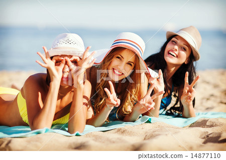 girls sunbathing on the beach girls sunbathing on the beach 14877110