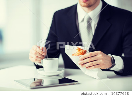 man with tablet pc and cup of coffee man with tablet pc and cup of coffee 14877638