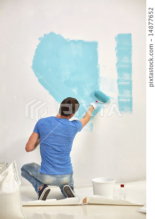 man with roller painting wall in blue at home man with roller painting wall in blue at home 14877652