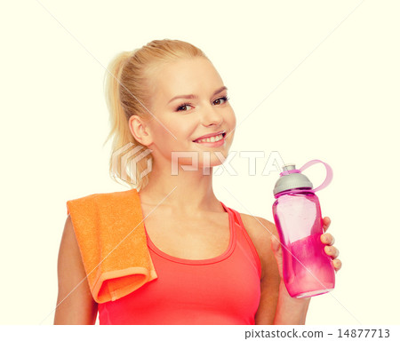 smiling sporty woman with water bottle and towel smiling sporty woman with water bottle and towel 14877713