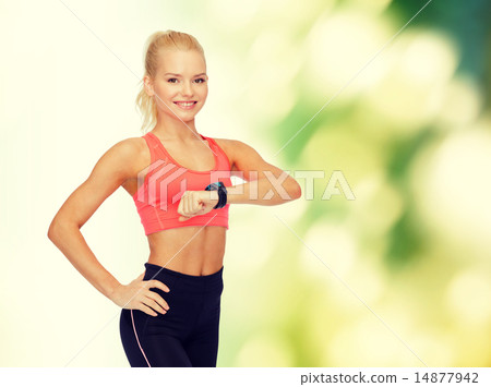 smiling woman with heart rate monitor on hand 14877942