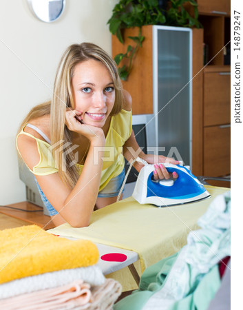 Girl ironing at home 14879247