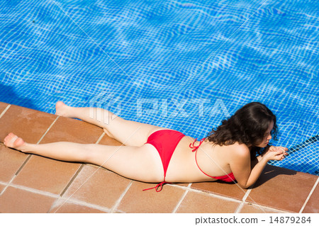 Girl in bikini resting near pool 14879284