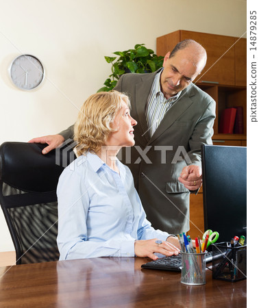 office scene with two mature and happy workers office scene with two mature and happy workers 14879285
