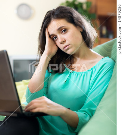 Sad woman using laptop 14879286