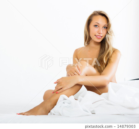 beautiful nude girl sitting on bed 14879303