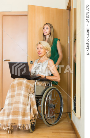 Social worker and invalid with laptop 14879370