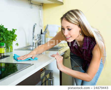 Woman cleaning kitchen 14879443
