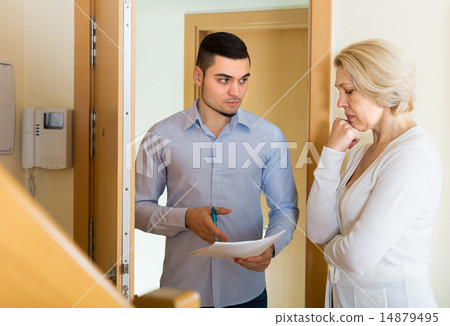 Serious man and housewife at the door 14879495