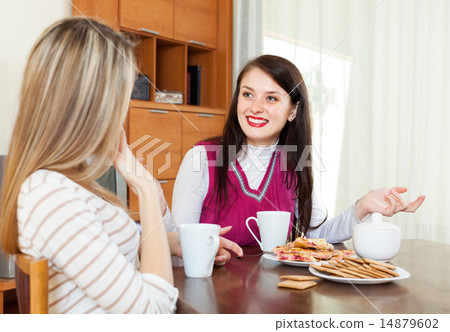 two happy women drinking tea and gossiping 14879602