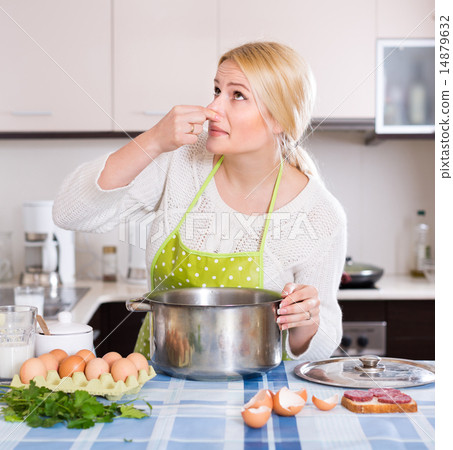 Woman feeling bad smell from pan Woman feeling bad smell from pan 14879632