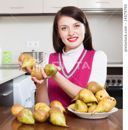 Happy young housewife with pears Happy young housewife with pears 14879760