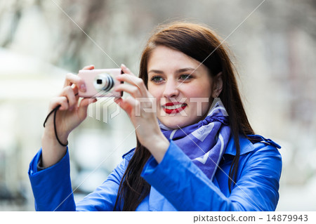 Happy girl with digital camera taking a photo 14879943