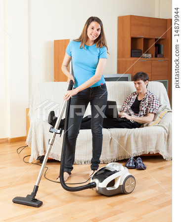 woman doing house cleaning with vaccuum cleaner 14879944