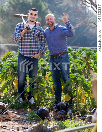 Happy gardeners with rubber hose 14880327