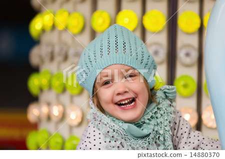 girl having ride on the merry-go-round 14880370