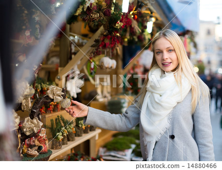 Blonde choosing christmas decorations 14880466