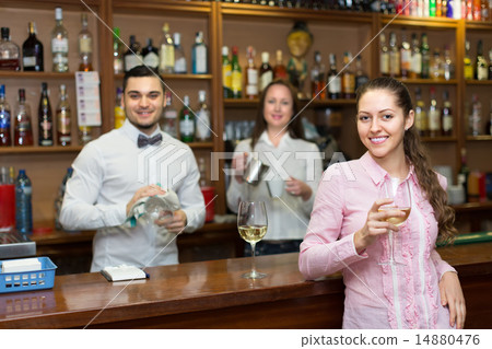 Girl flirting with barman at counter Girl flirting with barman at counter 14880476
