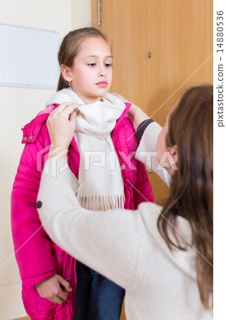 Woman helping girl to dress up Woman helping girl to dress up 14880536