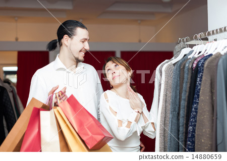 Two buyers with shopping bags at clothing shop 14880659