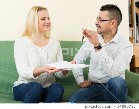 Couple with keys and documents Couple with keys and documents 14880753