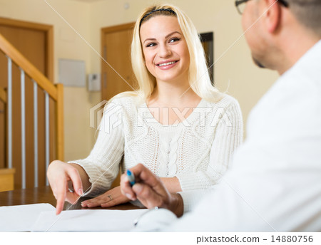 Couple filling in documents at home 14880756