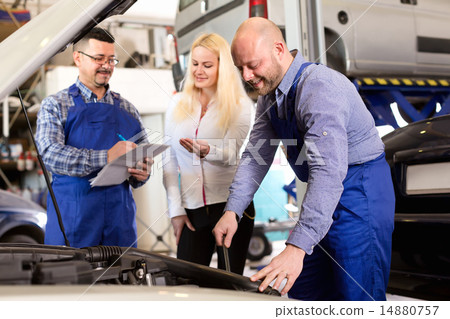 Service crew and driver near car 14880757