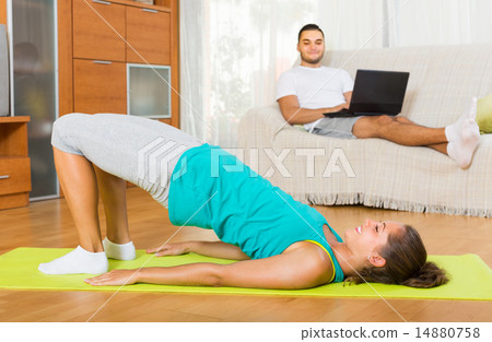 Girl doing yoga and man with laptop 14880758