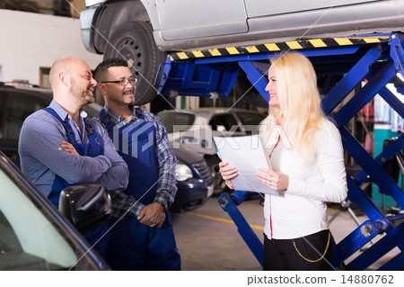 Woman and two auto mechanics Woman and two auto mechanics 14880762