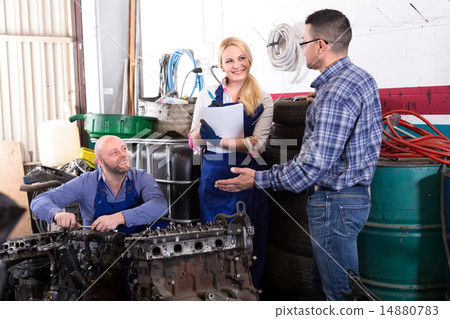 Mechanics repair engines at workshop Mechanics repair engines at workshop 14880783