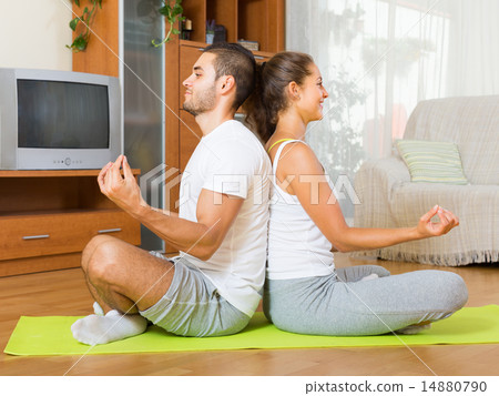 Couple having yoga class Couple having yoga class 14880790