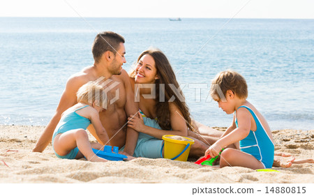 Family of four at the beach Family of four at the beach 14880815