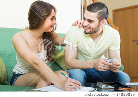Young couple calculating budget Young couple calculating budget 14880859